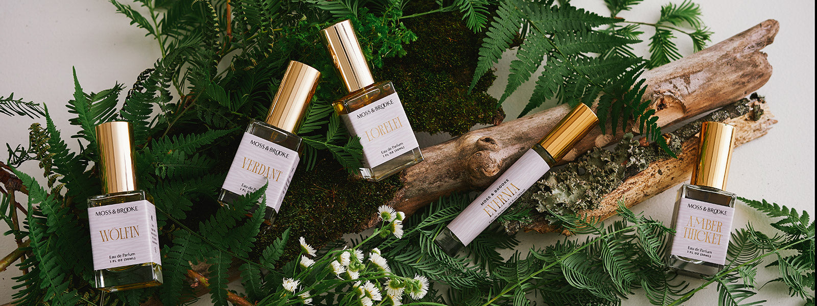 Moss & Brooke full range of botanical inspired fragrance with minimal packaging and gold foil.