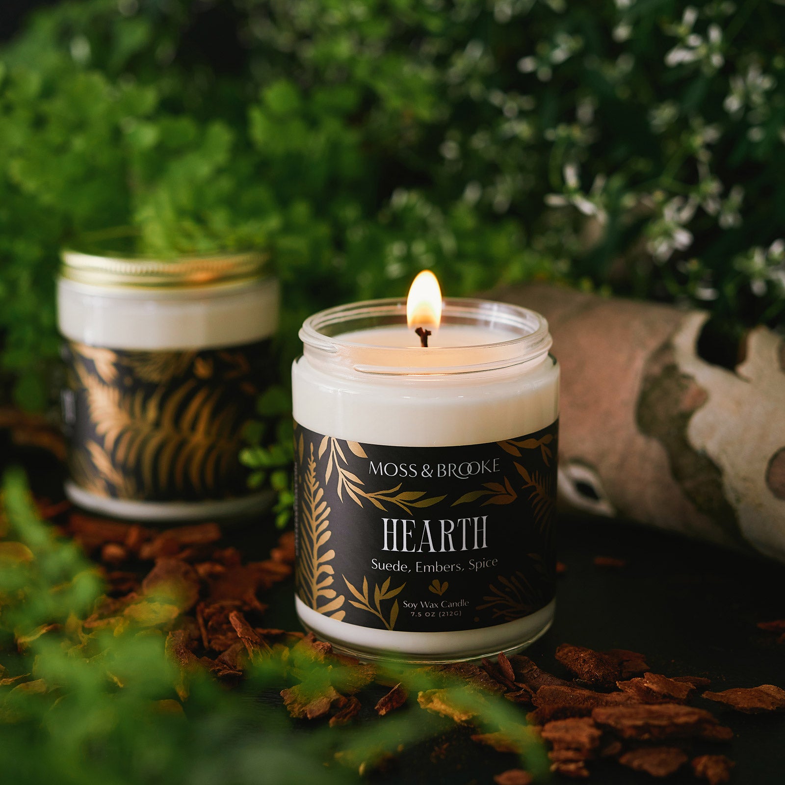 The Moss & Brooke candle in the scent Hearth features botanical inspired fragrance and lush golf foil packaging that's perfect for contemporary gifting. 